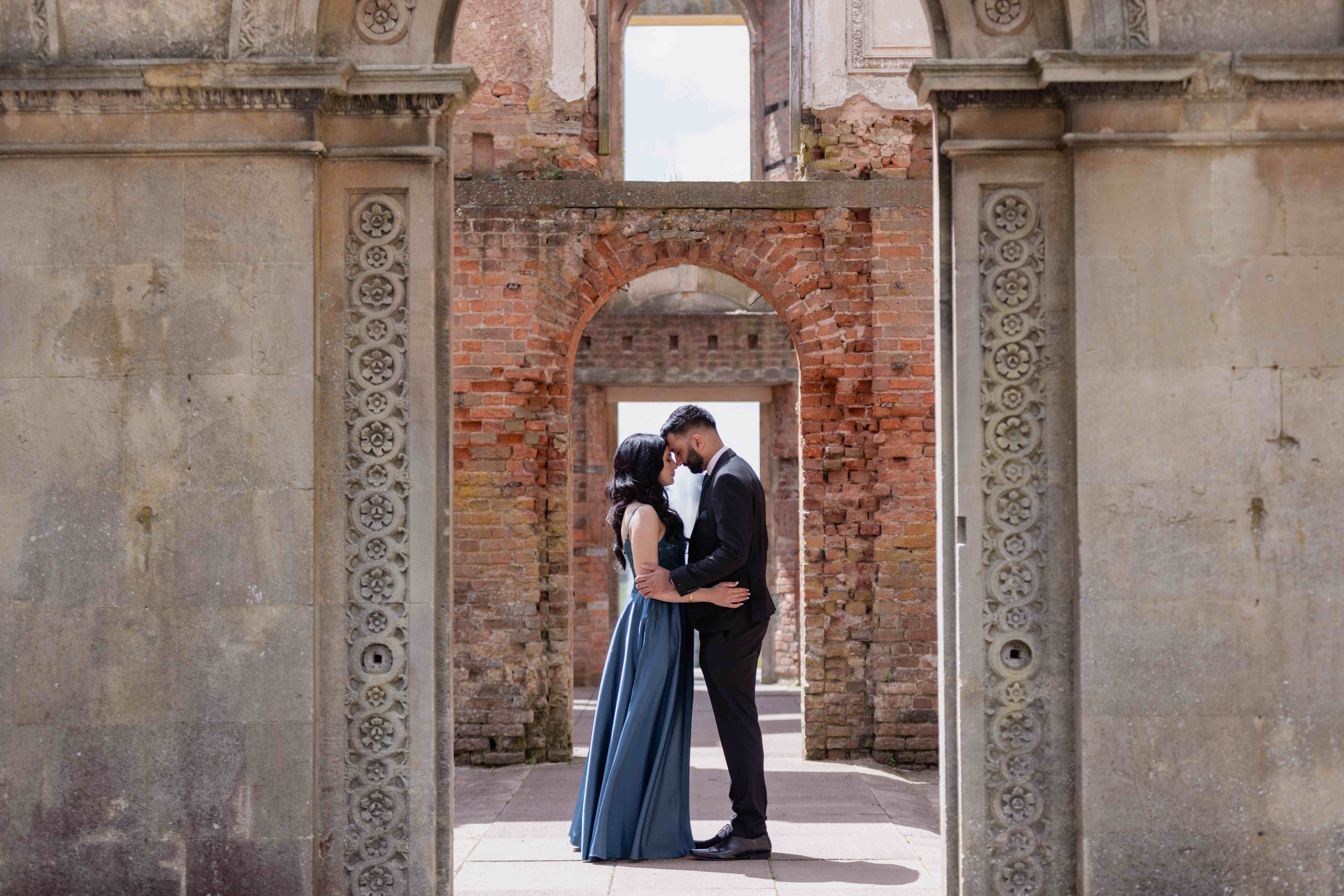 Intimate couple moment in historic brick archway