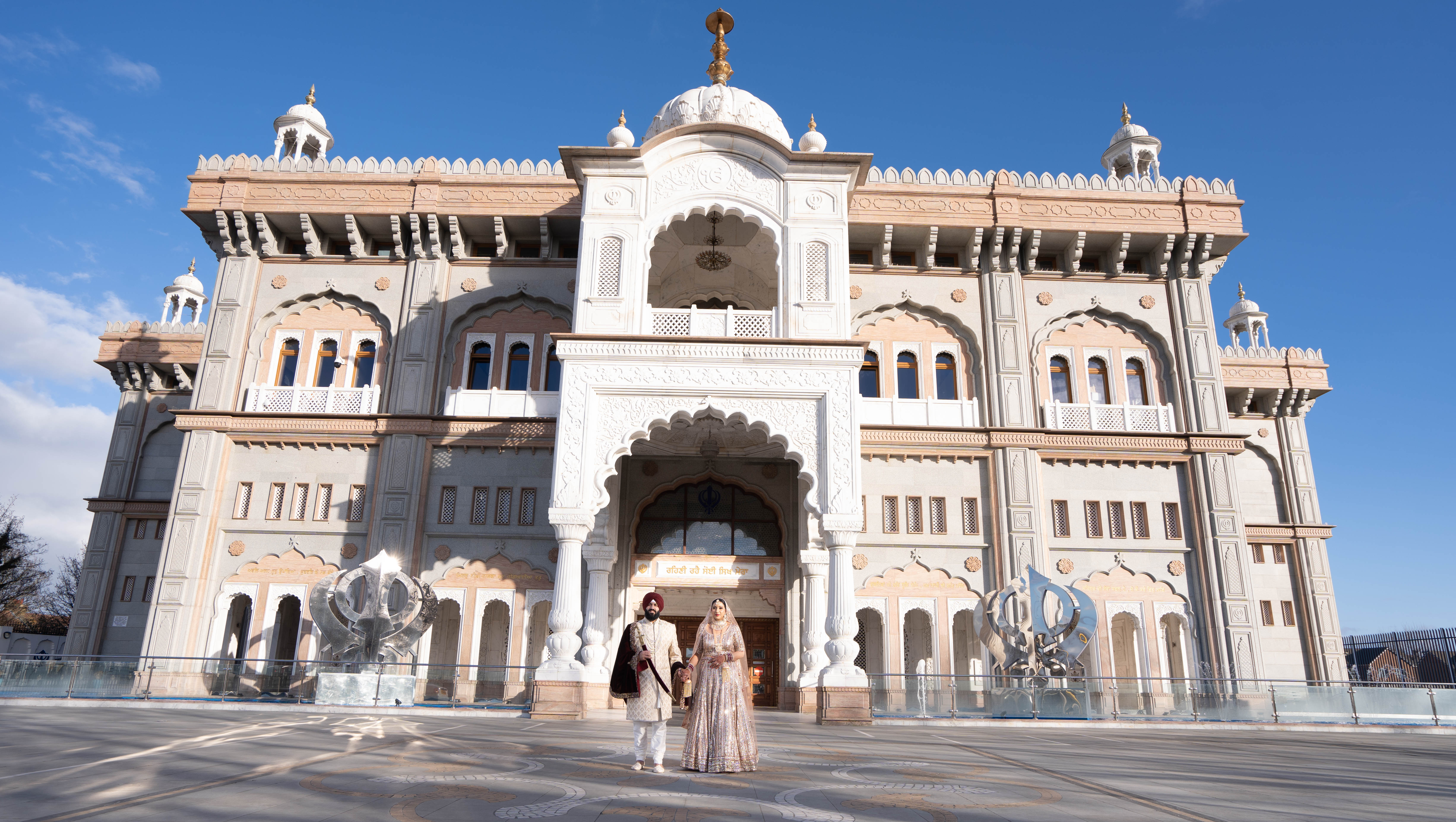 Wedding couple at stunning white Gurdwara temple