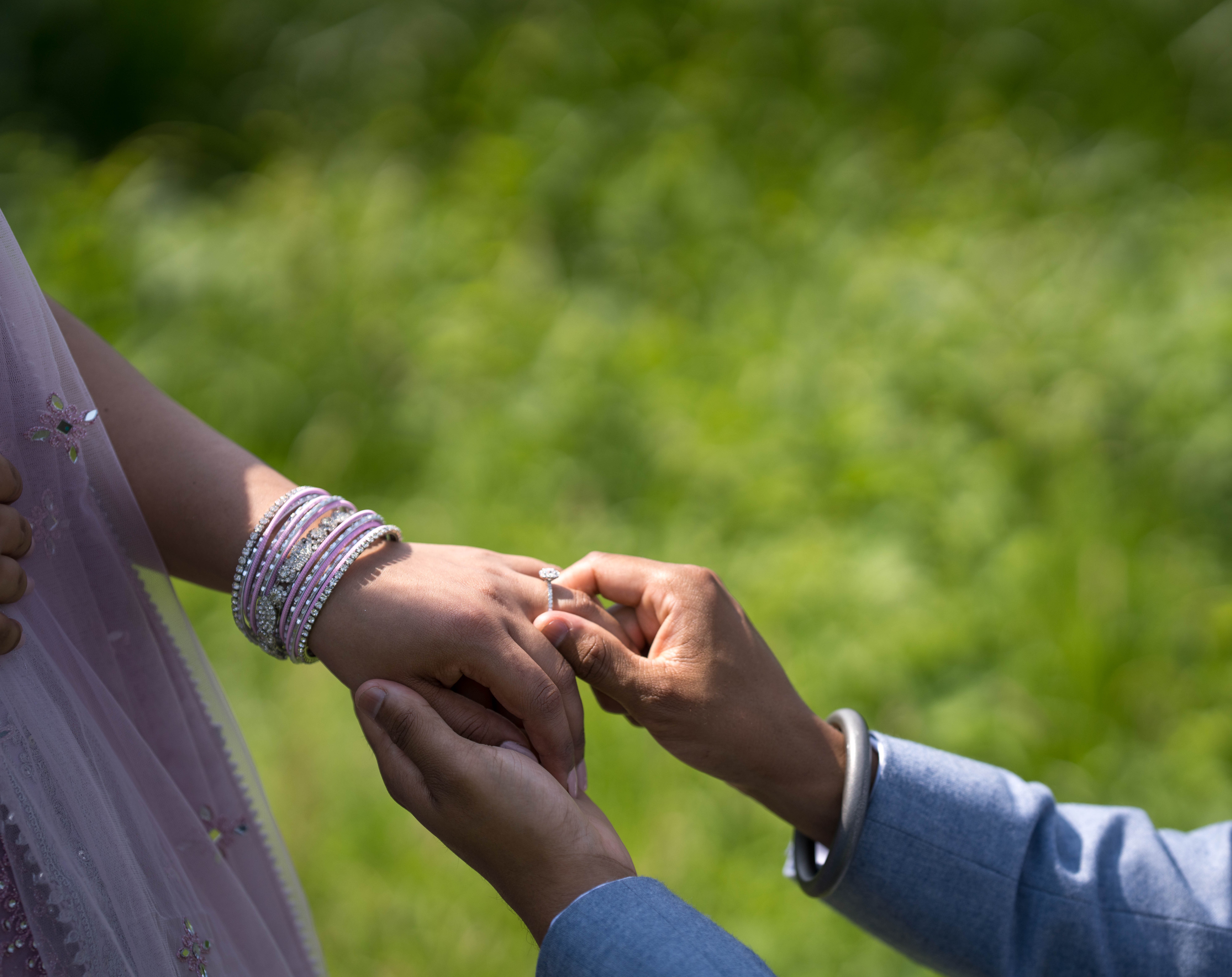 Ring exchange moment with lavender bangles in garden setting