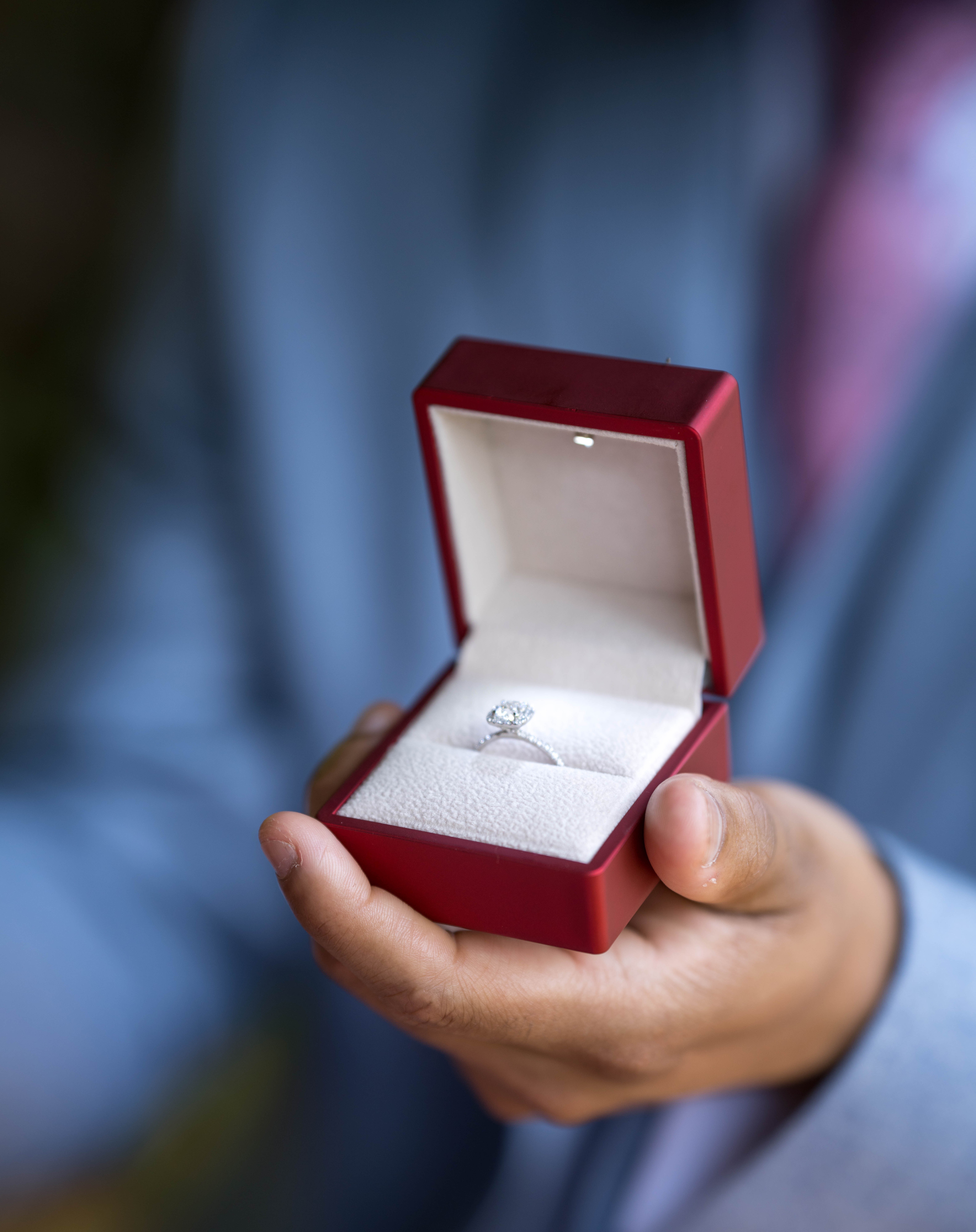 Engagement ring in red velvet box during proposal