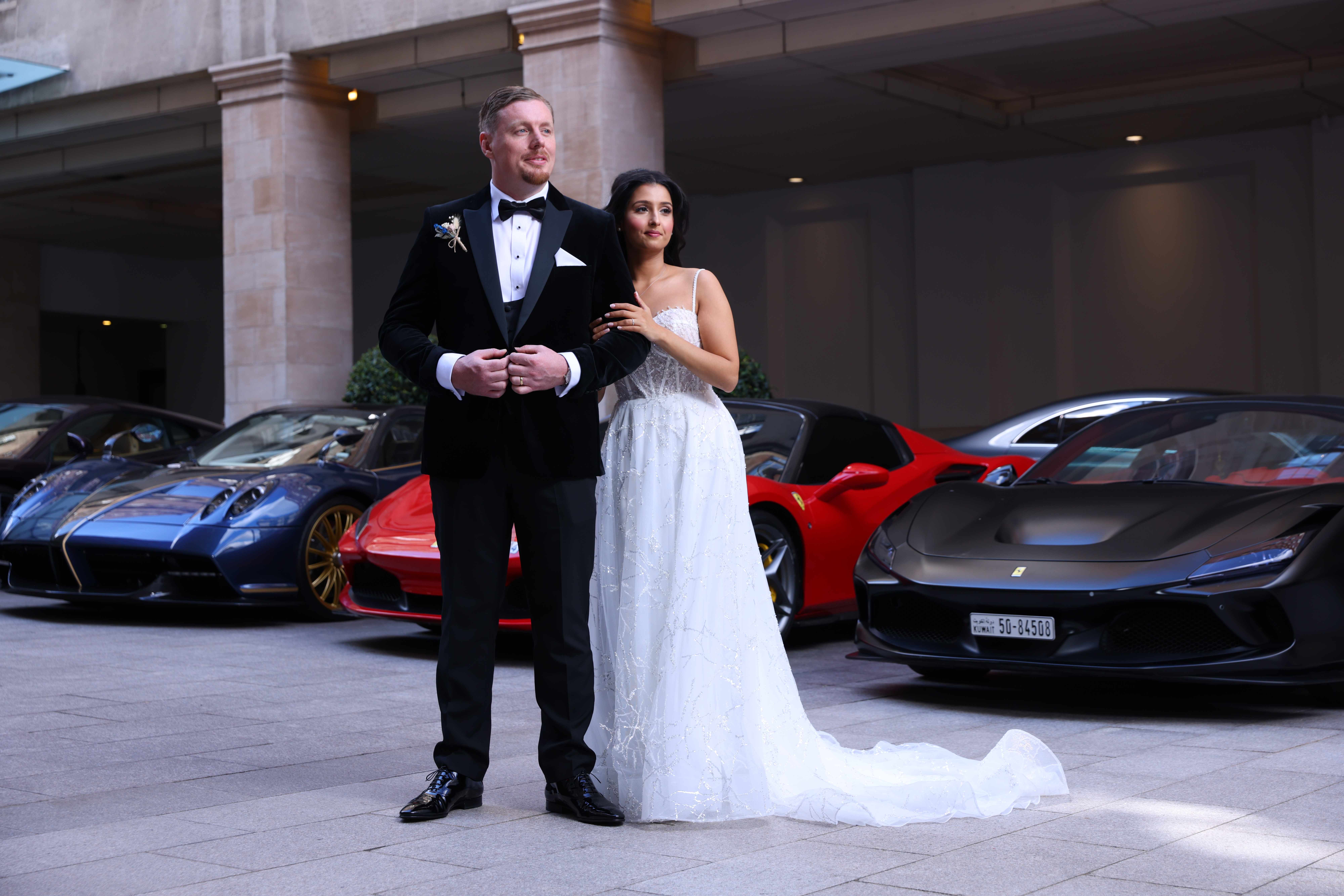 Wedding couple portrait with luxury sports cars