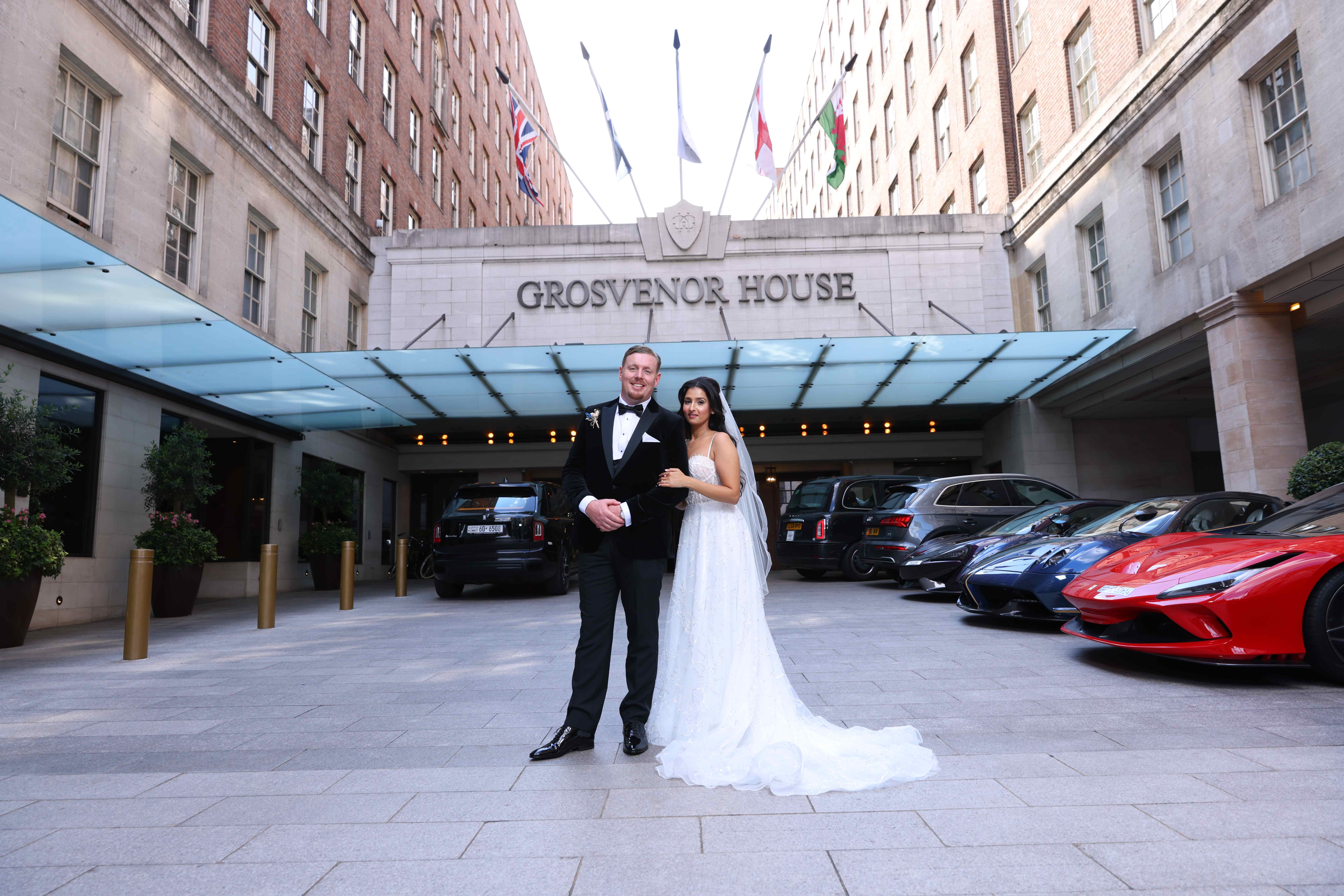 Wedding couple at Grosvenor House entrance